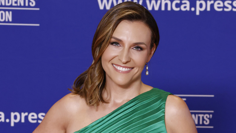 Mary Bruce with her hair swept over one shoulder in a green dress.