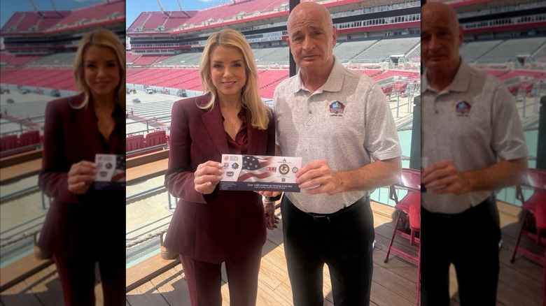 Pam Bondi smiling next to a man and holding a ticket.