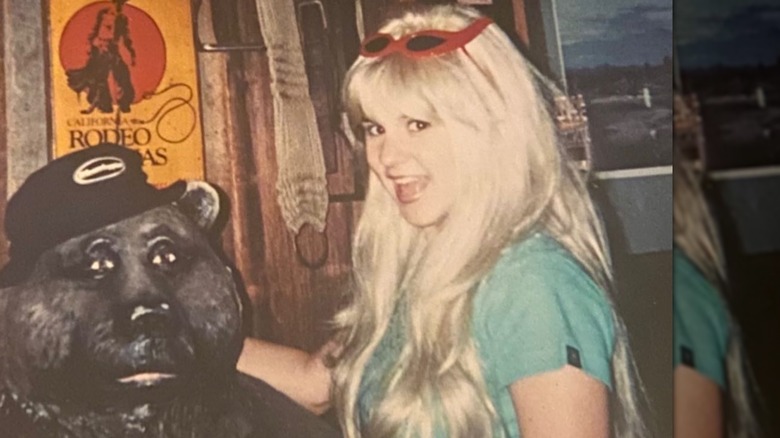 Brandi Passante posing with a statue of a bear