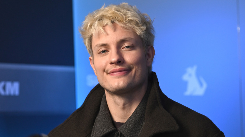 Matt Rife smiling at SiriusXM Studios in a black coat in December 2024