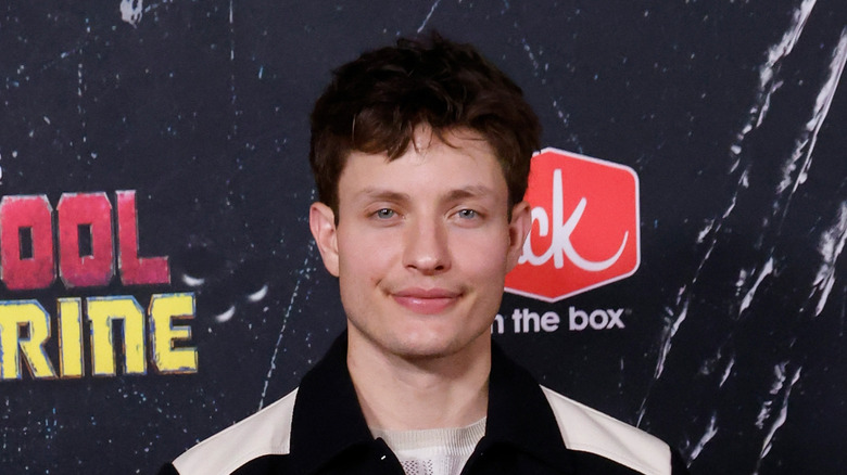 Matt Rife smiling while posing at the world premiere of "Deadpool & Wolverine" in a black and white shirt