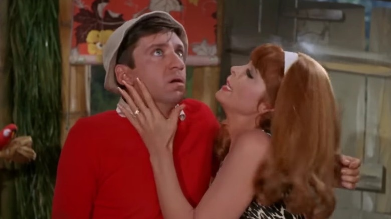 Bob Denver as Gilligan, with Tina Louise as Ginger draping herself on him dramatically, on Gilligan's Island
