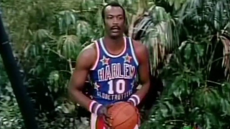A member of the Harlem Globetrotters holding a basketball on the island