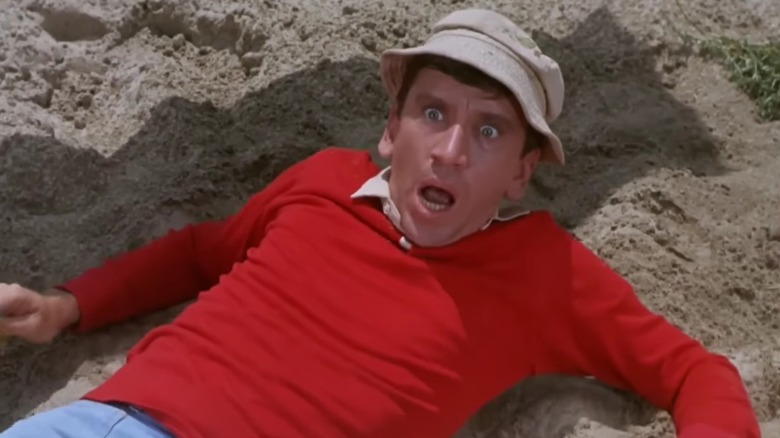 Bob Denver as Gilligan, laying on the beach and looking up in surprise, in Gilligan's Island