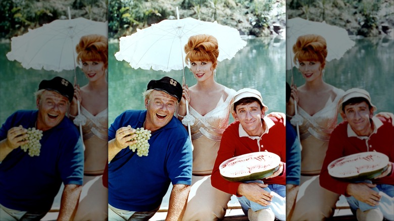 Alan Hale Jr. as The Skipper, Tina Louise as  Ginger, and Bob Denver as Gilligan posing for a promotional photo
