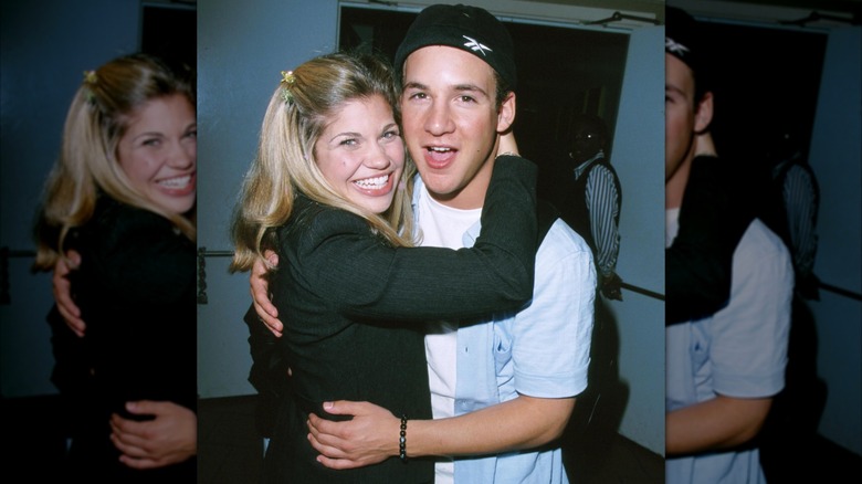Danielle Fishel and Ben Savage smiling and embracing in the '90s