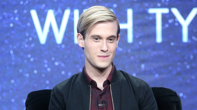 Tyler Henry sitting during a panel in 2016
