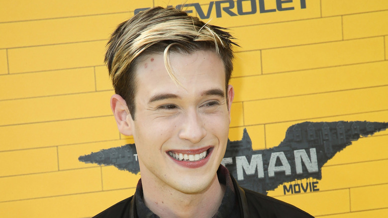 Tyler Henry smiling and posing at a premiere in 2017