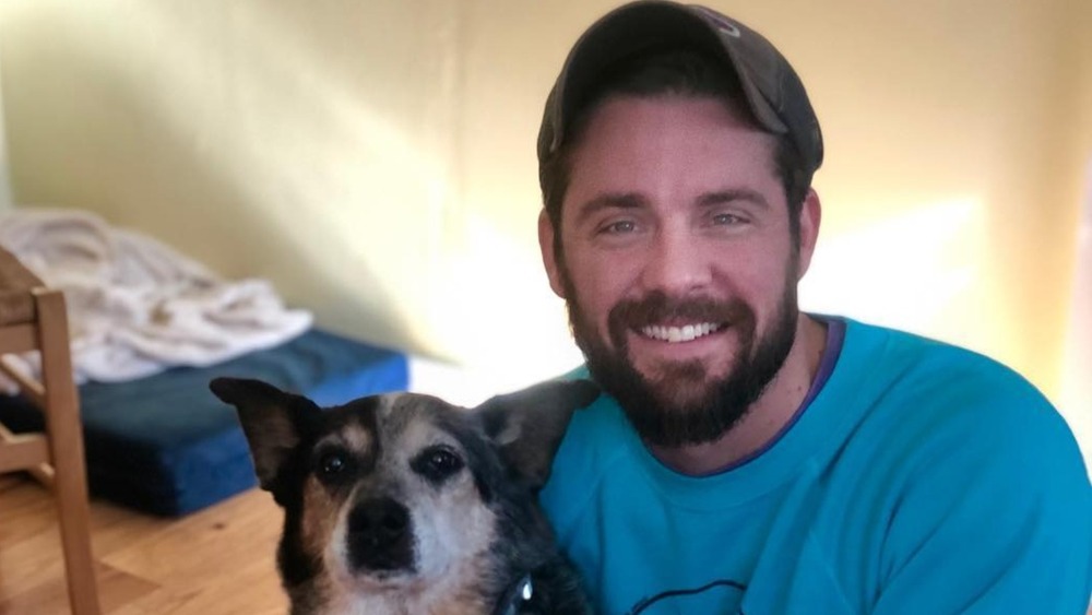 Below Deck's Eddie poses with his dog