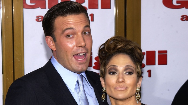 Ben Affleck smiling and posing with Jennifer Lopez.