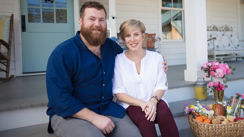 Ben and Erin Napier posing on their front porch