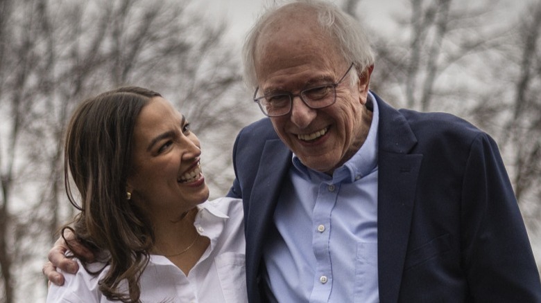 Alexandria Ocasio-Cortez and Bernie Sanders share a moment onstage at a rally in Denver, CO (2025)