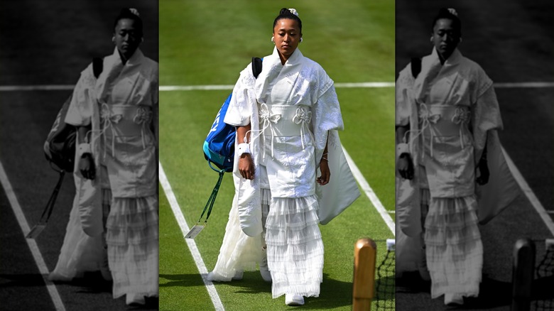 Naomi Osaka enters the court at Wimbledon 2026 in an extravagant white outfit.