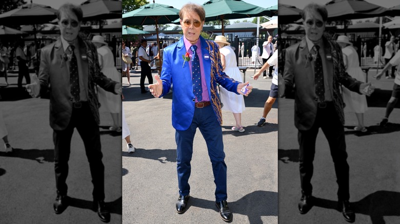 Sir Cliff Richard posing with his arms open at Wimbledon 2026.