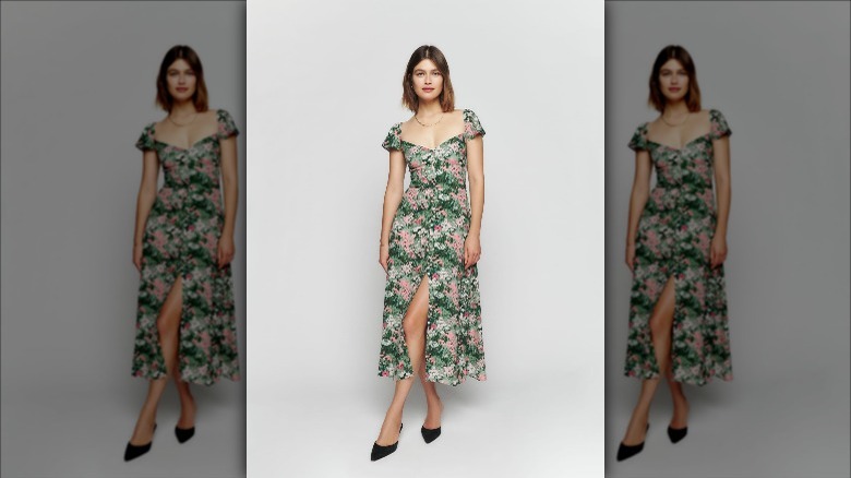 Reformation model wears floral midi