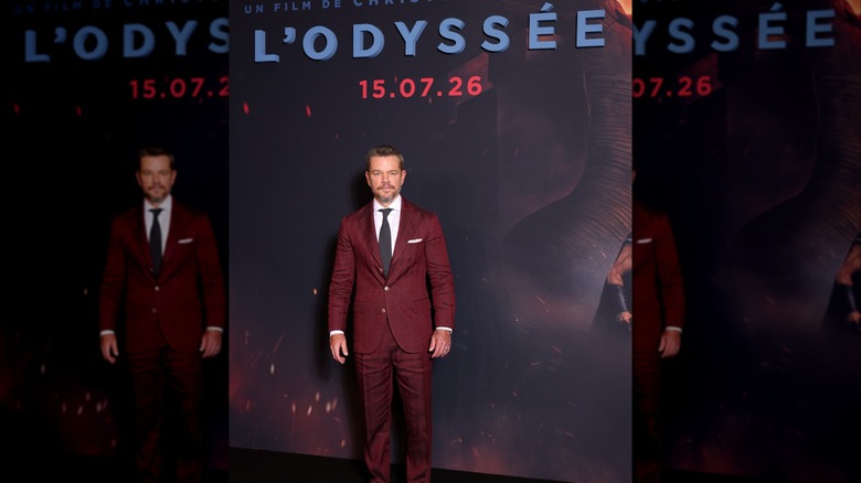 Matt Damon smiling in a red suit