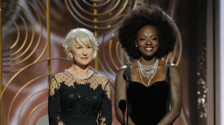 Helen Mirren standing beside Viola Davis on stage
