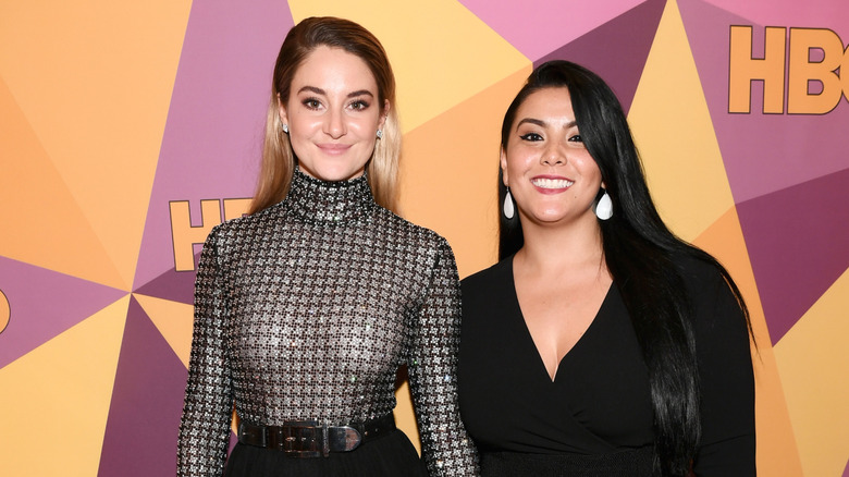 Two actors smiling on the red carpet