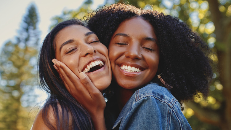 best friends smiling at camera,