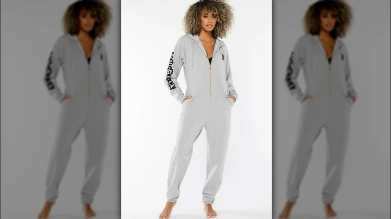 Woman wearing a gray onesie pajama