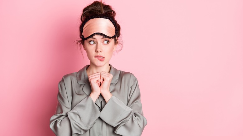 Woman in pajamas making a decision