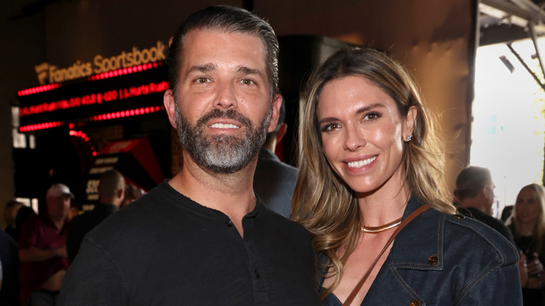Donald Trump Jr. and Bettina Anderson smiling while posing at an event together