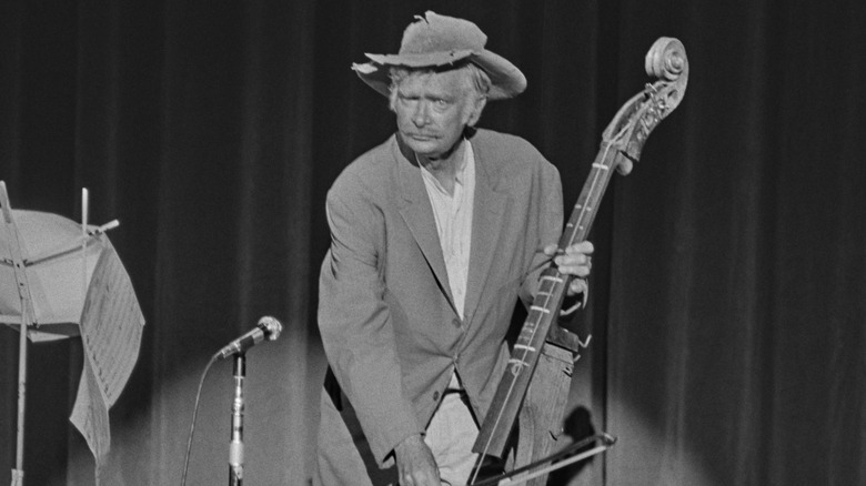 Buddy Ebsen in costume as Jed Clampett holding an instrument