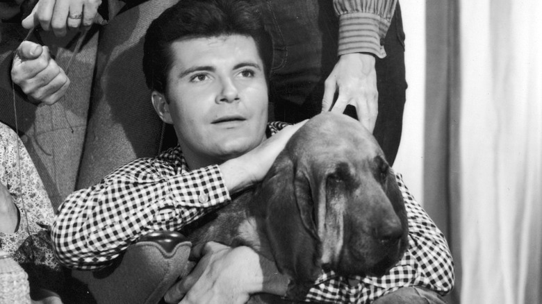 Max Baer Jr. holding a dog