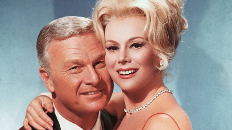 Eva Gabor putting her arms around Eddie Albert