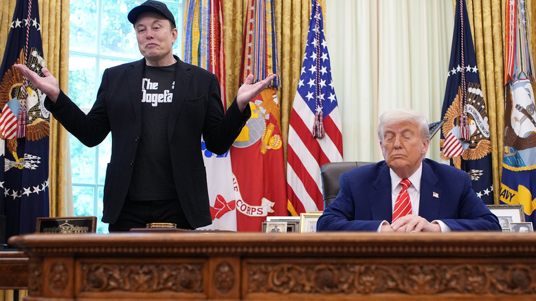Elon Musk shrugging while Donald Trump looks down at his desk