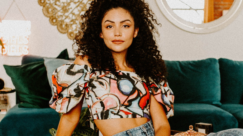 Bianca A. Santos posing on green furniture