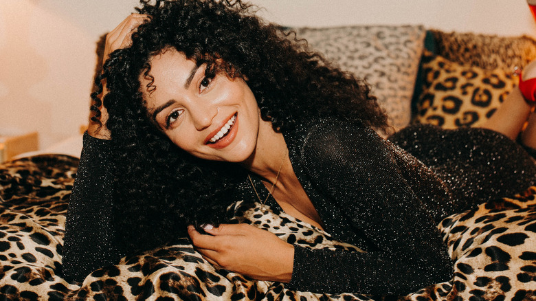Bianca A. Santos smiling on a bed