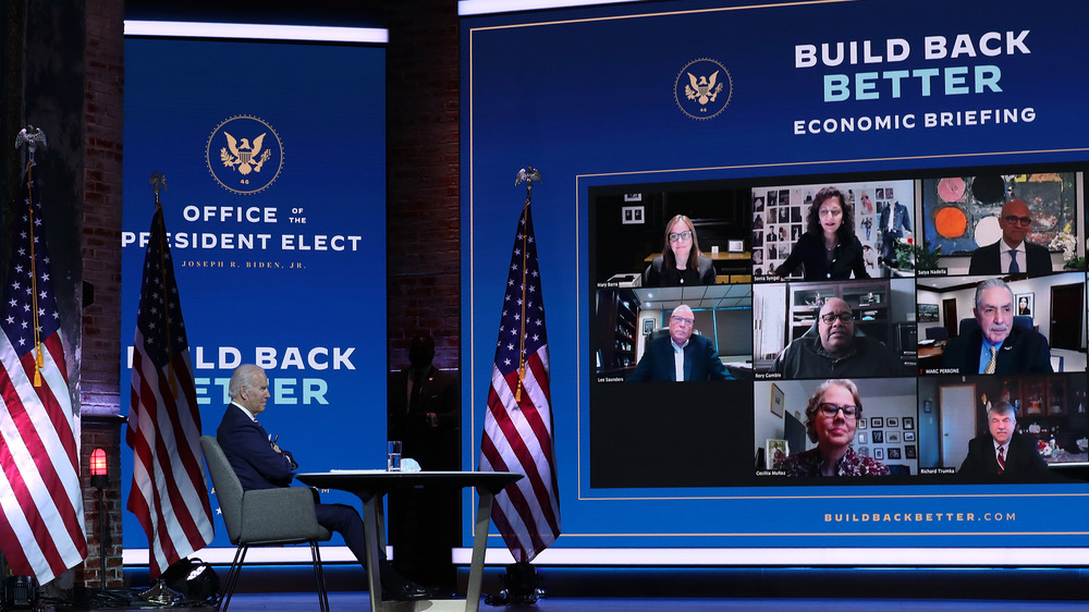 Biden speaking to advisers on a video wall