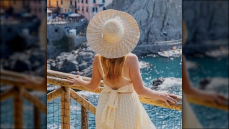 woman wearing summer beach hat and dress
