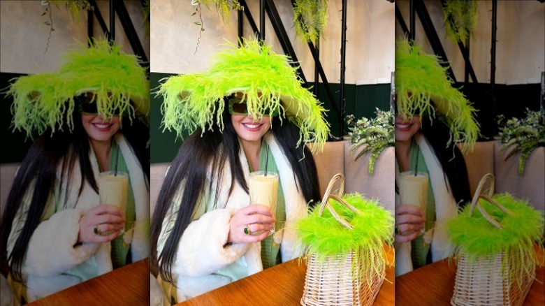 woman wearing neon green feather hat