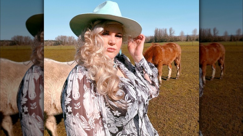 woman wearing light blue cowboy hat