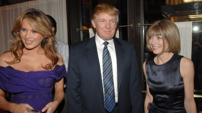 Anna Wintour smiling with Melania and Donald Trump