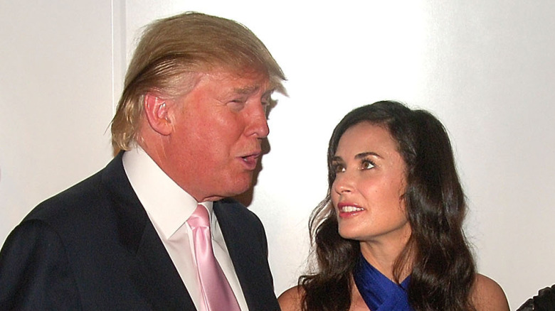 Demi Moore in a blue dress with Donald Trump