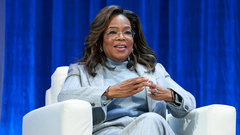 Oprah Winfrey in a powder blue turtleneck and suit
