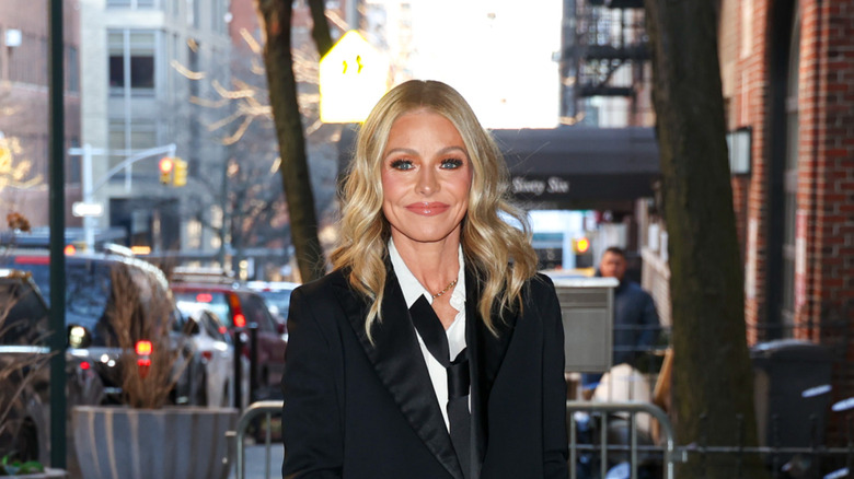 Kelly Ripa smiling in a suit