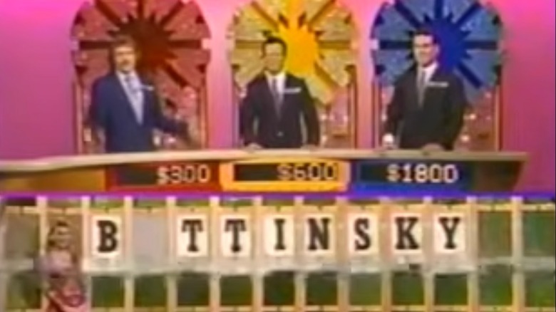 Contestants guessing a puzzle on "Wheel of Fortune"