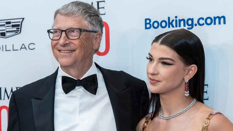 Bill Gates smiling beside his daughter Phoebe Gates on the red carpet