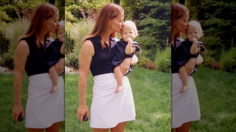 Young Melinda Gates holding a baby Phoebe in a throwback photo