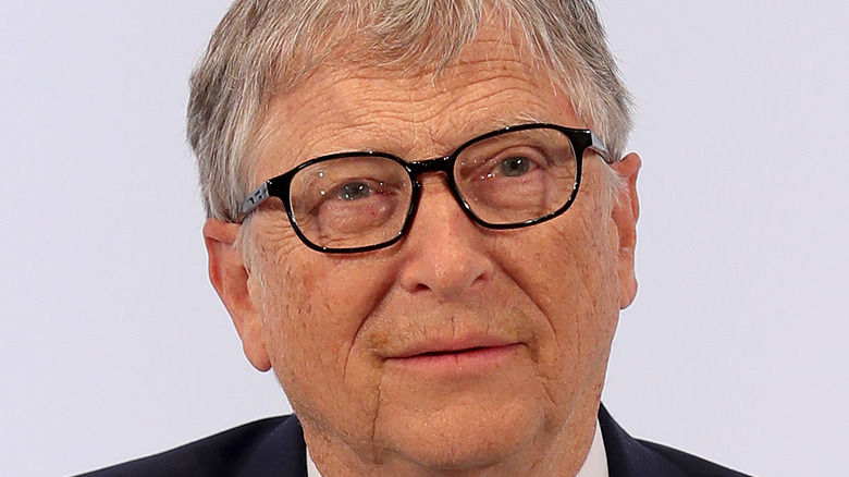 Bill Gates tilting his head with slightly parted lips