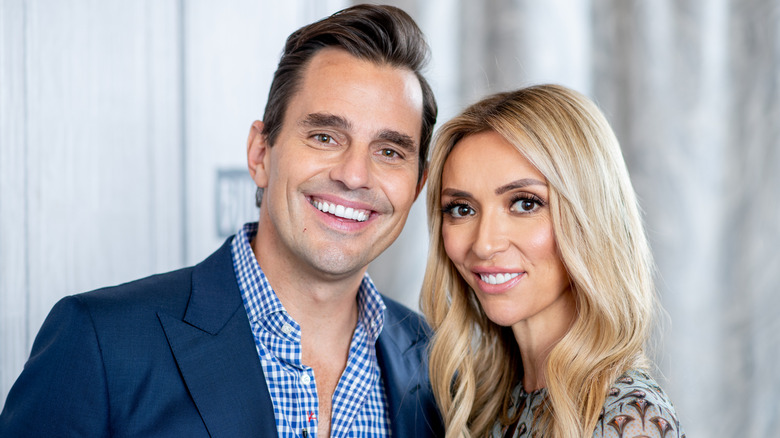 Bill and Giuliana Rancic smiling while posing for photos together