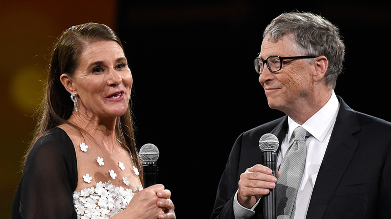 Melinda and Bill holding microphones