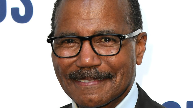 Bill Whitaker smiling in glasses and moustache