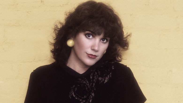 Linda Ronstadt posing with her head tilted in a black lace top