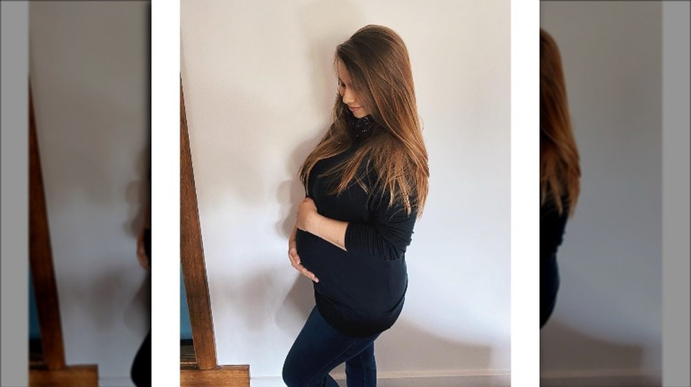 Bindi Irwin cradles her baby bump
