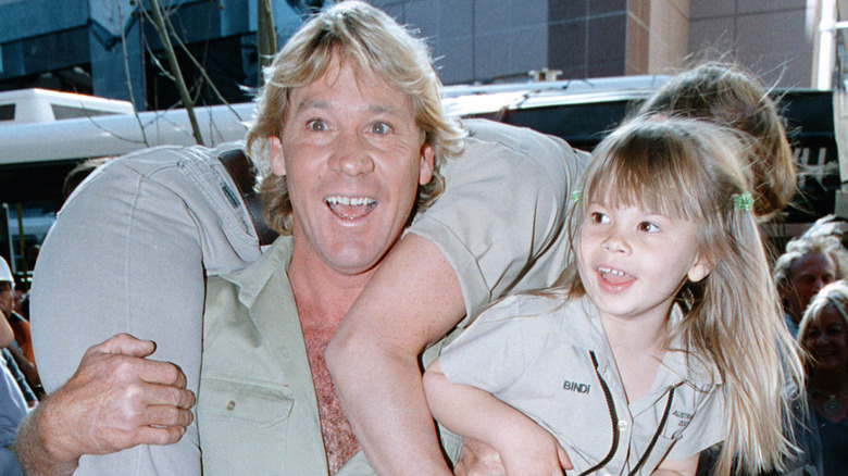 Steve Irwin holding Bindi and Terri Irwin.
